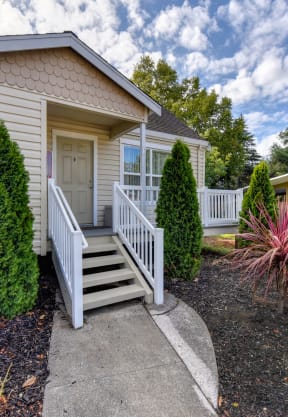 the front of a home with stairs and a porch at Vineyard Terrace Apartments, Napa, CA