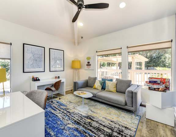 a living room with a gray couch and a blue rug at Renaissance Park Apartments, California, 95618