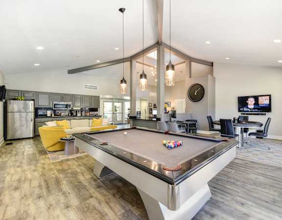 a resident clubhouse with a pool table and a flat screen tv at Renaissance Park Apartments, California, 95618