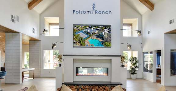 a living room with a fireplace and a television above it at Folsom Ranch, California, 95630
