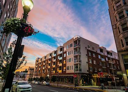 a building on a city street at sunset