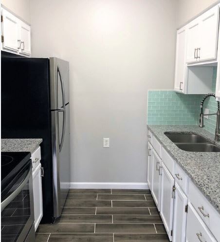 a kitchen with a sink and a refrigerator