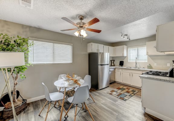an open kitchen and dining room with a white table and chairs at Desert Bay Apartments, Laughlin, Nevada, 89029