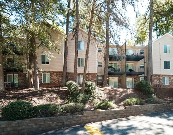 our apartments are located in a quiet area with trees and bushes at Hidden Woods, Decatur, GA