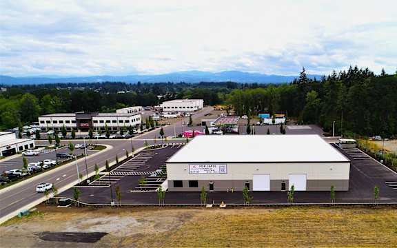 an aerial view of a building in a parking lot