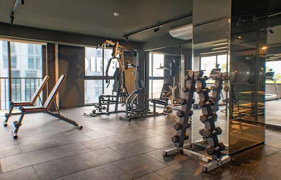 A gym with a variety of equipment including a leg press machine.
