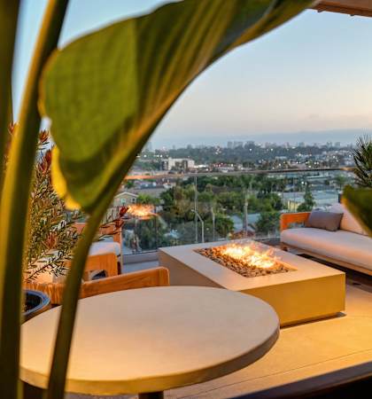 a terrace with a couch and a fire pit