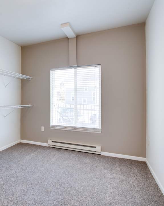 an empty room with a large window and wooden floors at Urban Crossing Apartments, Fargo, ND, 58103