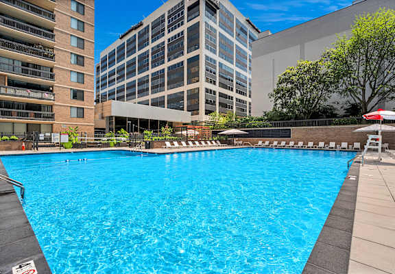 A large swimming pool in front of a building.