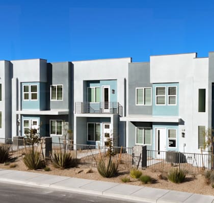 A row of modern houses with blue and grey exteriors.