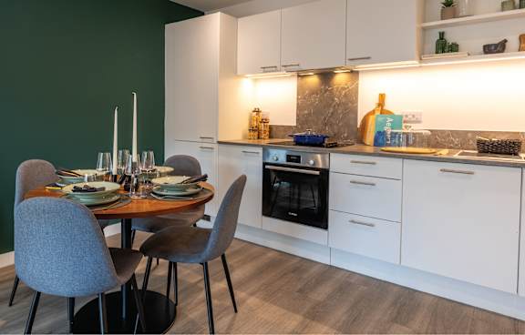 a kitchen with navy blue cabinets and a white counter top