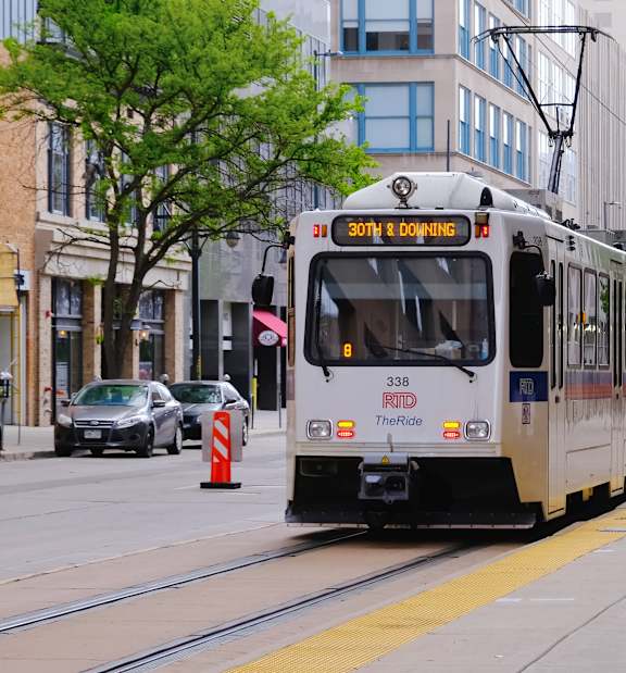 A streetcar with the number 338 on it is on a street.