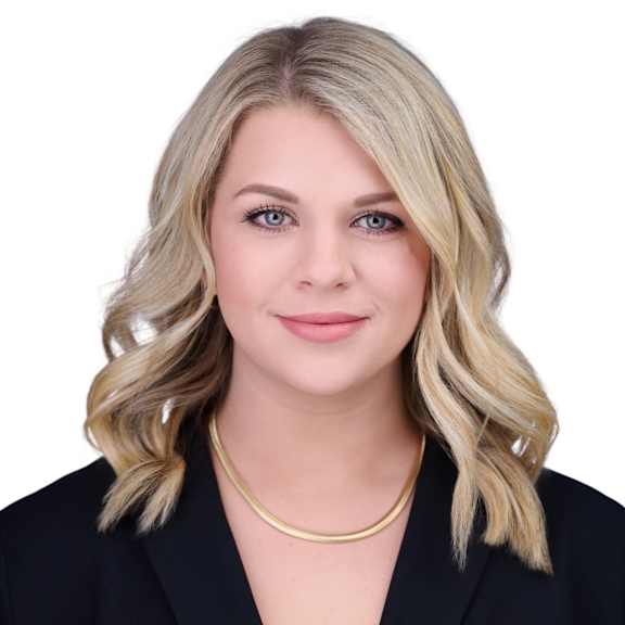 A woman with blonde hair and a black blazer.