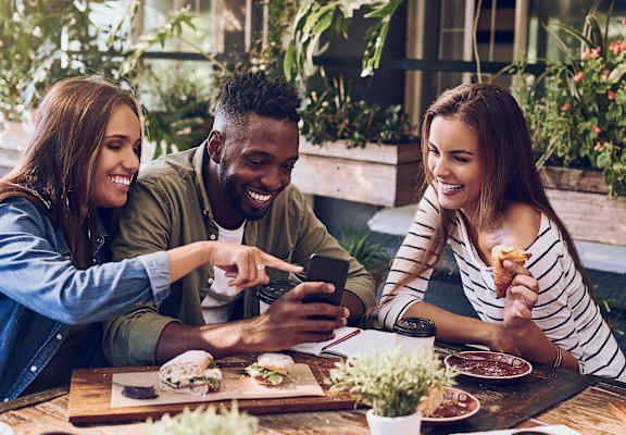 a group of people sitting around a table eating food