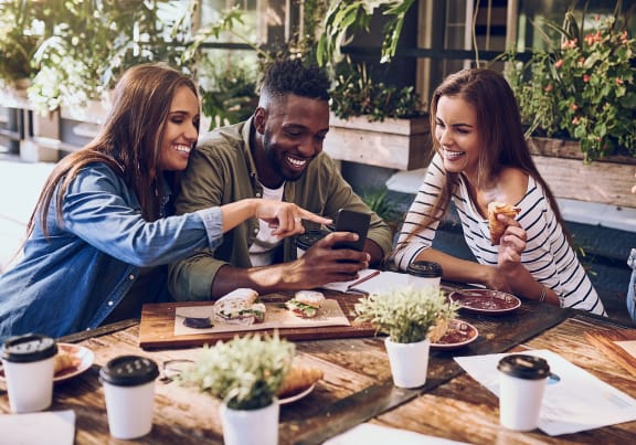 a group of people sitting around a table eating food