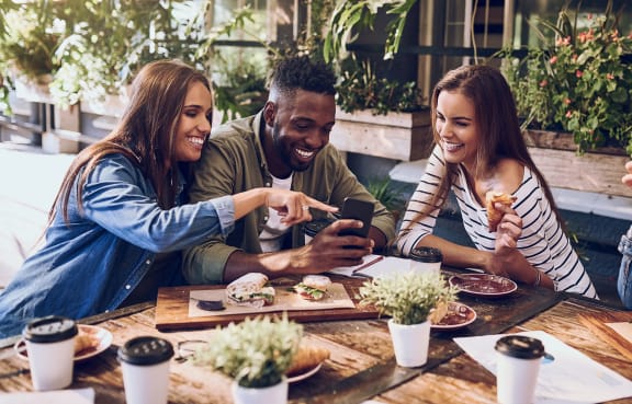 a group of people sitting around a table eating food