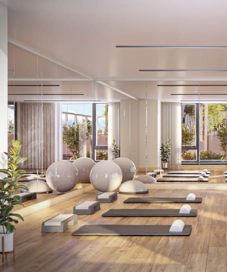 a yoga studio with white spheres and yoga balls on the floor