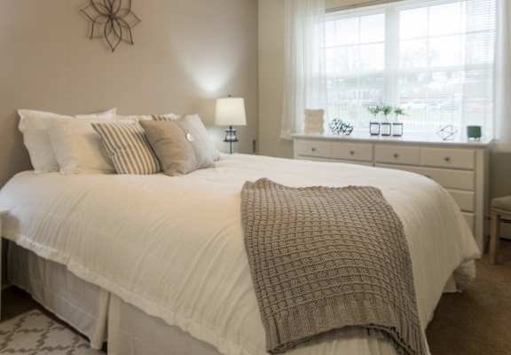 This is a photo of the bedroom of the 1 bedroom, 631 square foot model apartment at Lake of the Woods Apartments in Cincinnati, OH.