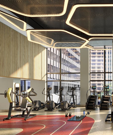 a gym with weights and exercise equipment in a building with tall windows