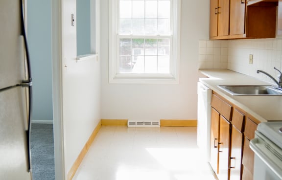 an empty kitchen with a sink and a window