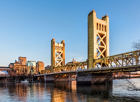 a bridge over a river with a city in the background at FREMONT MEWS, California, 95814
