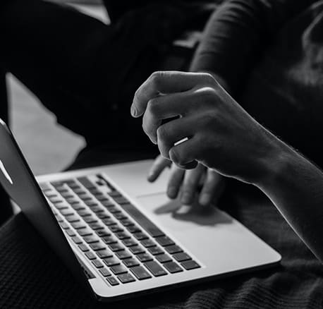 a person typing on a laptop computer