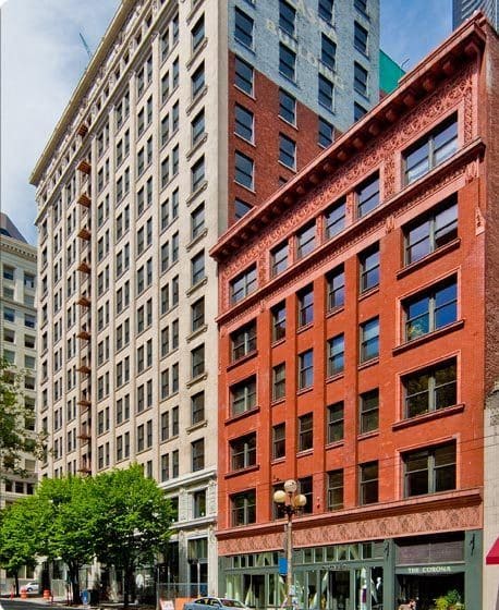 a tall red brick building with a tall white building