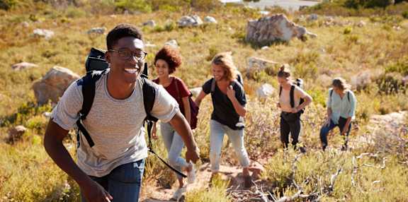 A group of people hiking in a rocky terrain.