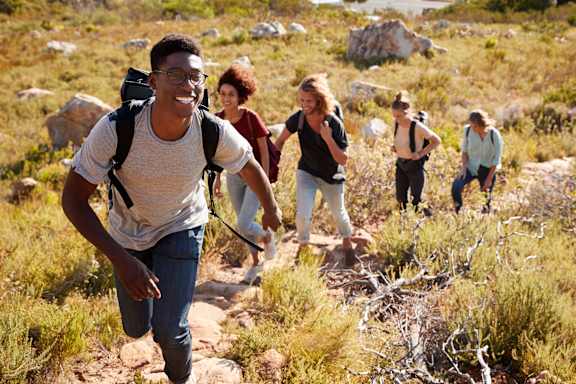 A group of people hiking in a rocky terrain.
