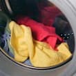 A washing machine with clothes in it.