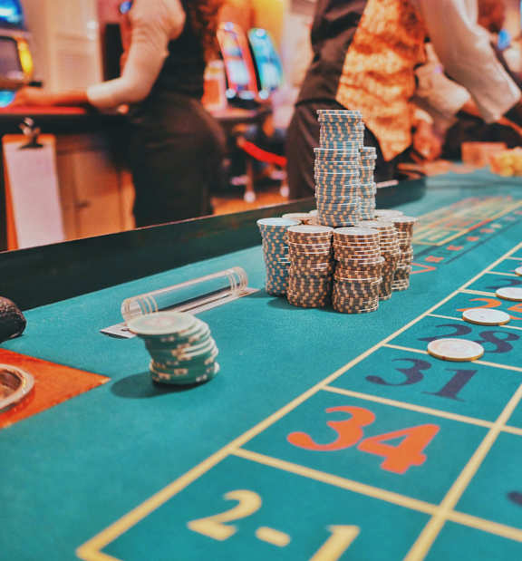 A casino roulette table with a stack of chips on it.