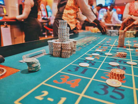 A casino roulette table with a stack of chips on it.