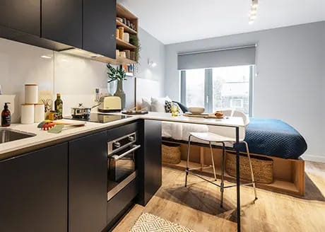 a kitchen and a dining room with a table and chairs