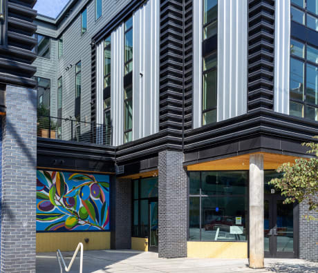 A building with a mural of fruit on the side.