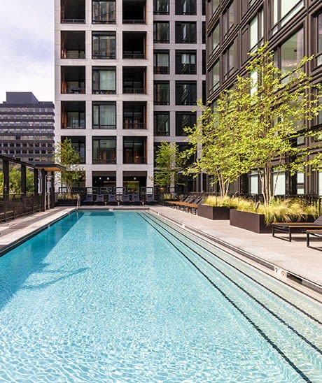 a swimming pool in front of a building at The Grace and Reva, Arlington, Virginia