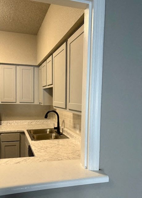 A kitchen with a sink and cabinets.