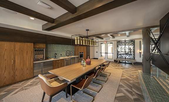 a large dining room with a wooden table and chairs