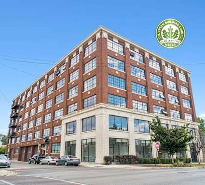 a large brick building with many windows on a city street