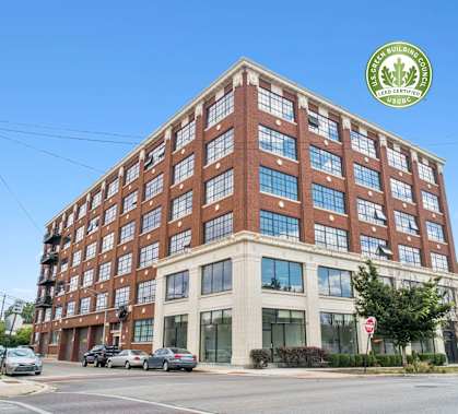 a large brick building with many windows on a city street