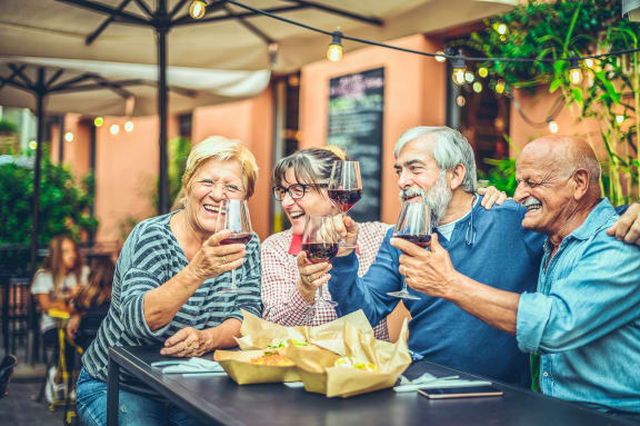 a group of people sitting at a table drinking wine