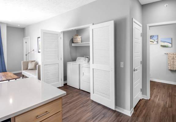A kitchen with white appliances and cabinets.