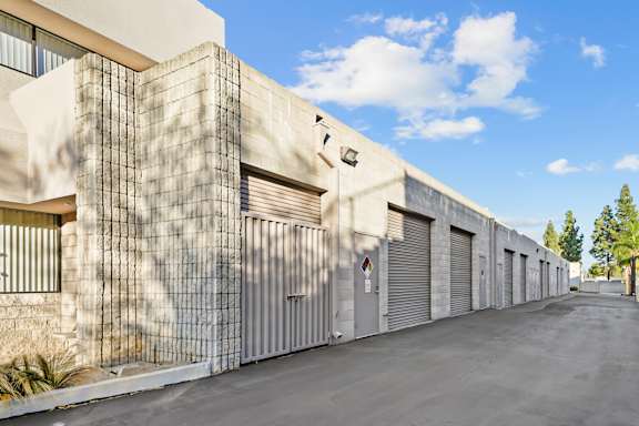 A long row of garage doors are closed.