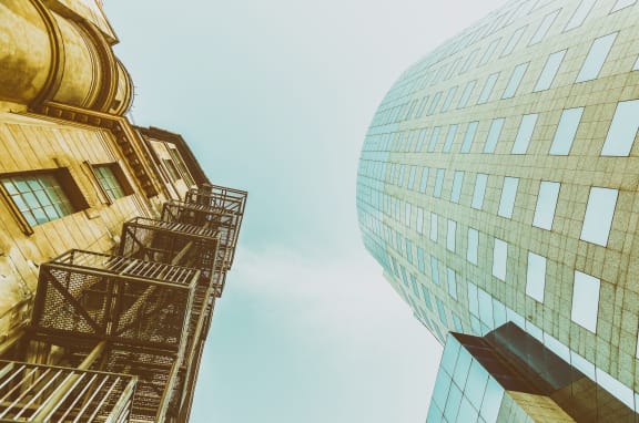 two tall buildings with the sky in the background