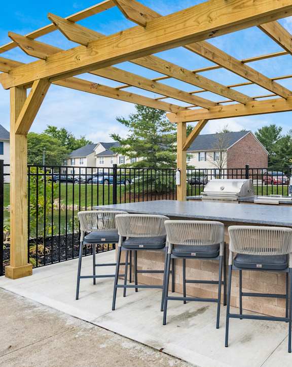 a rendering of a patio with a bar and a pergola