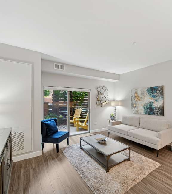 A modern kitchen with a dining table and a couch.