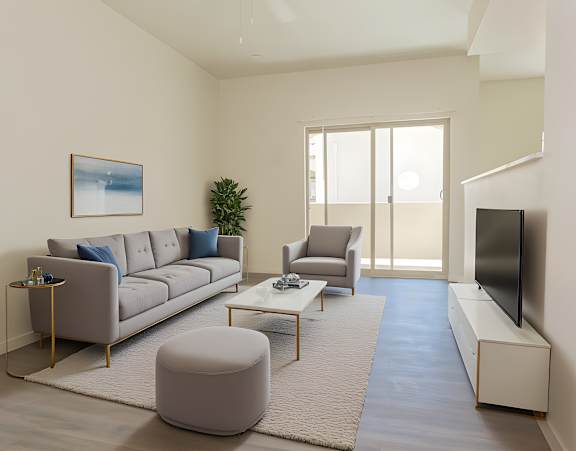 A living room with a grey sofa, a grey armchair, a grey ottoman, a coffee table, a flat screen TV, and a painting on the wall.
