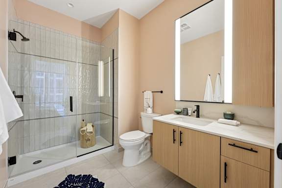 A bathroom with a toilet, sink, and shower.