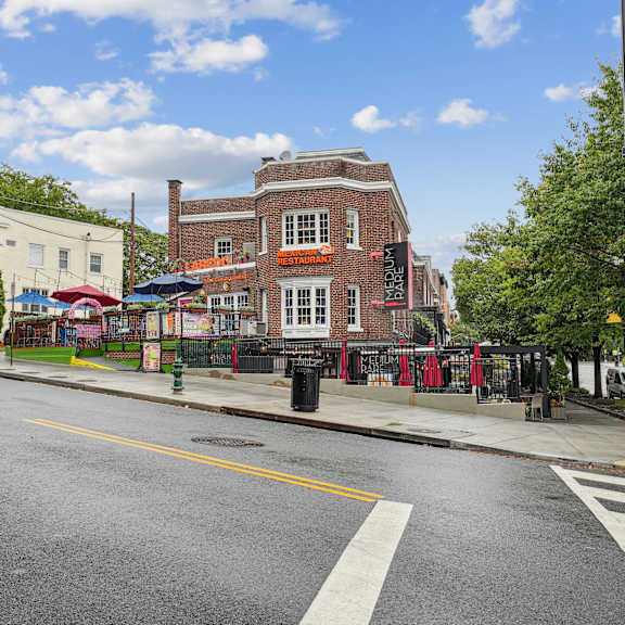 A city street with a crosswalk and traffic lights.