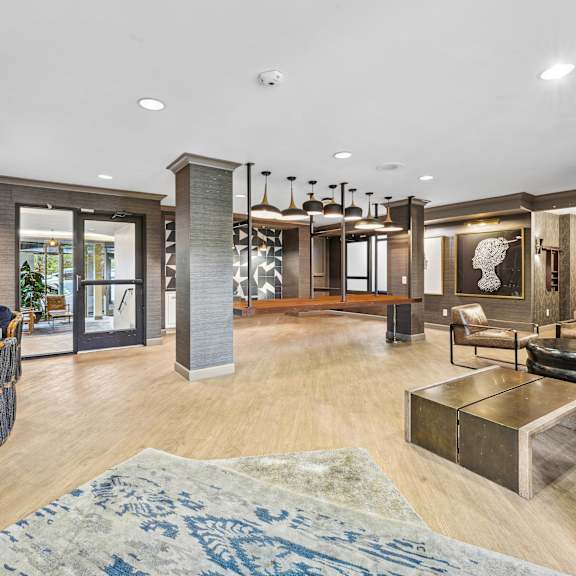 A living room with a blue rug on the floor.