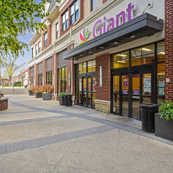 A brick building with a purple sign that says Giant.